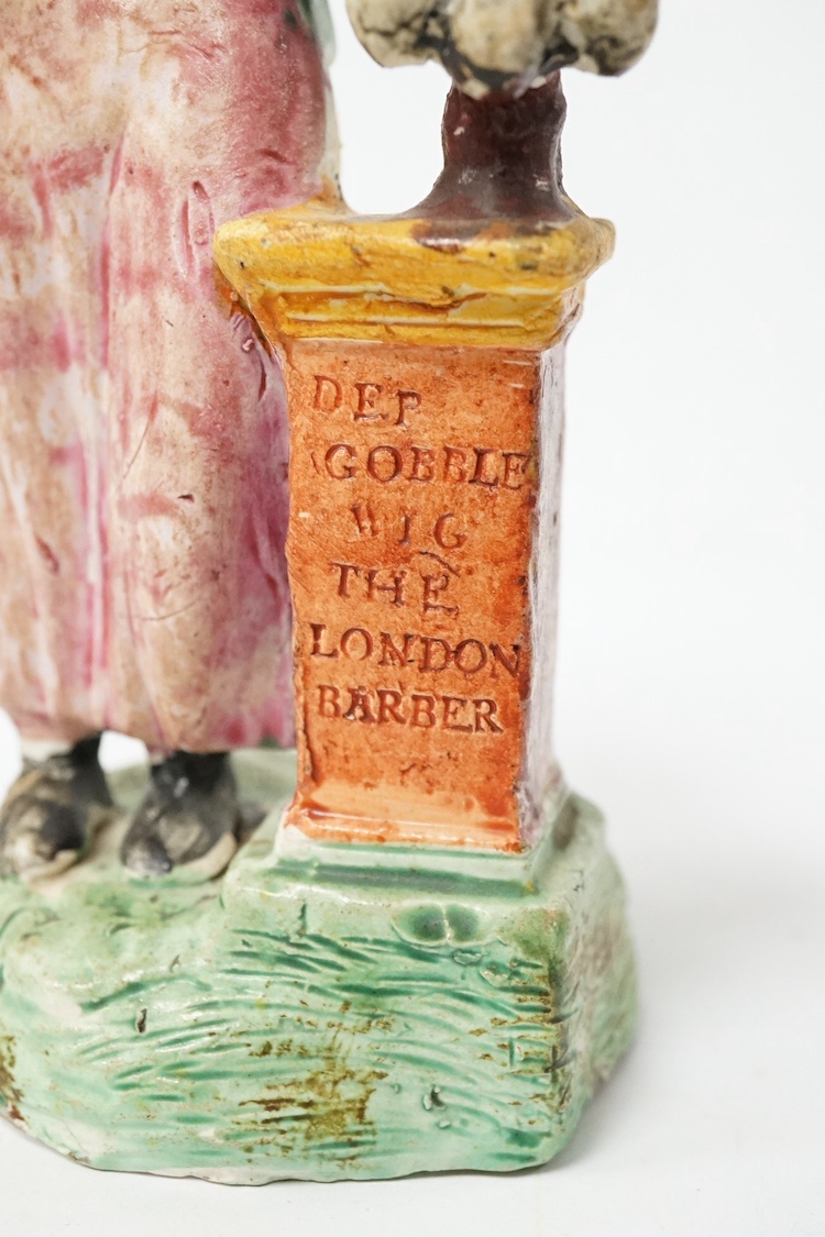 An exceedingly rare Staffordshire coloured biscuit figure of the London Barber, c.1795–1800, 15.5cm high. Condition - possibly a test piece that is misfired and not over glazed with some roughness to the base, evidence o